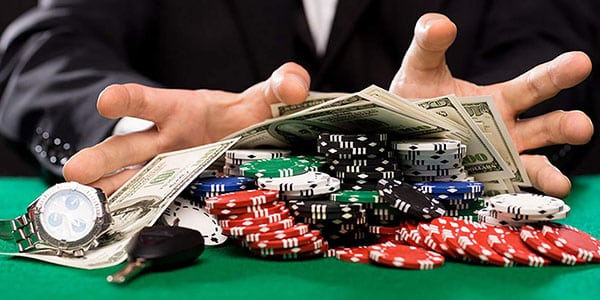 Cash casino chips, keys and watch, problem gambling