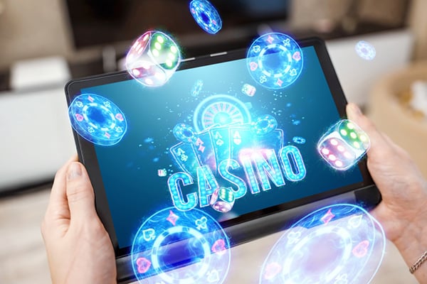 Hands on Tablet with Neon Casino Gambling Games